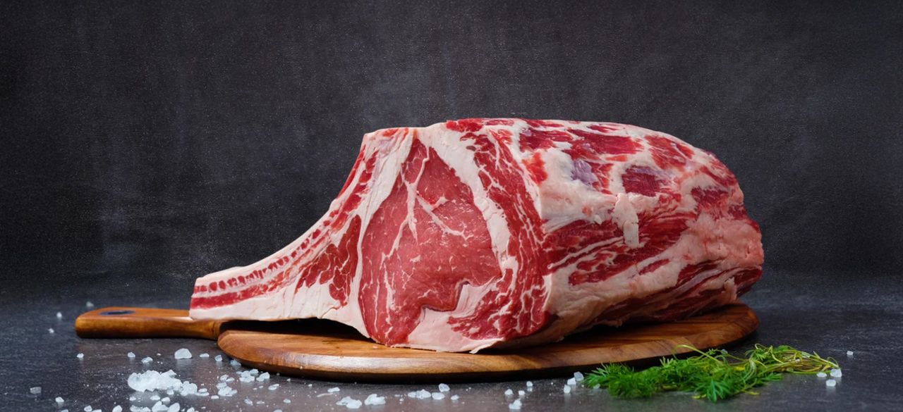 why-choose-us-img High-quality raw ribeye beef on a wooden board, perfect for gourmet cooking.
